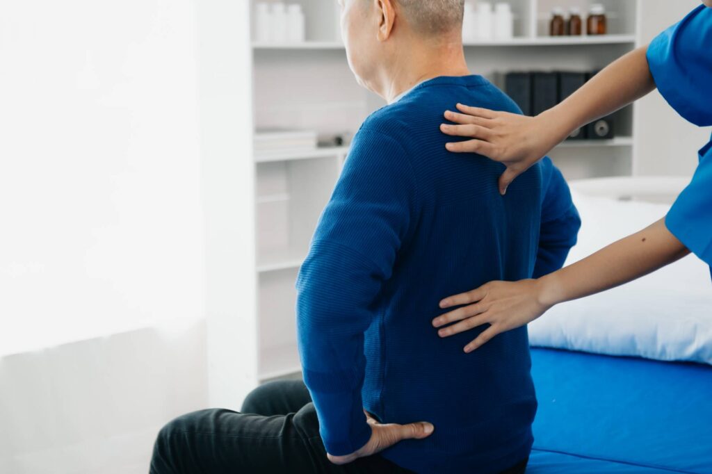 octor consulting with patient Back problems Physical on the bed in clinic therapy concept